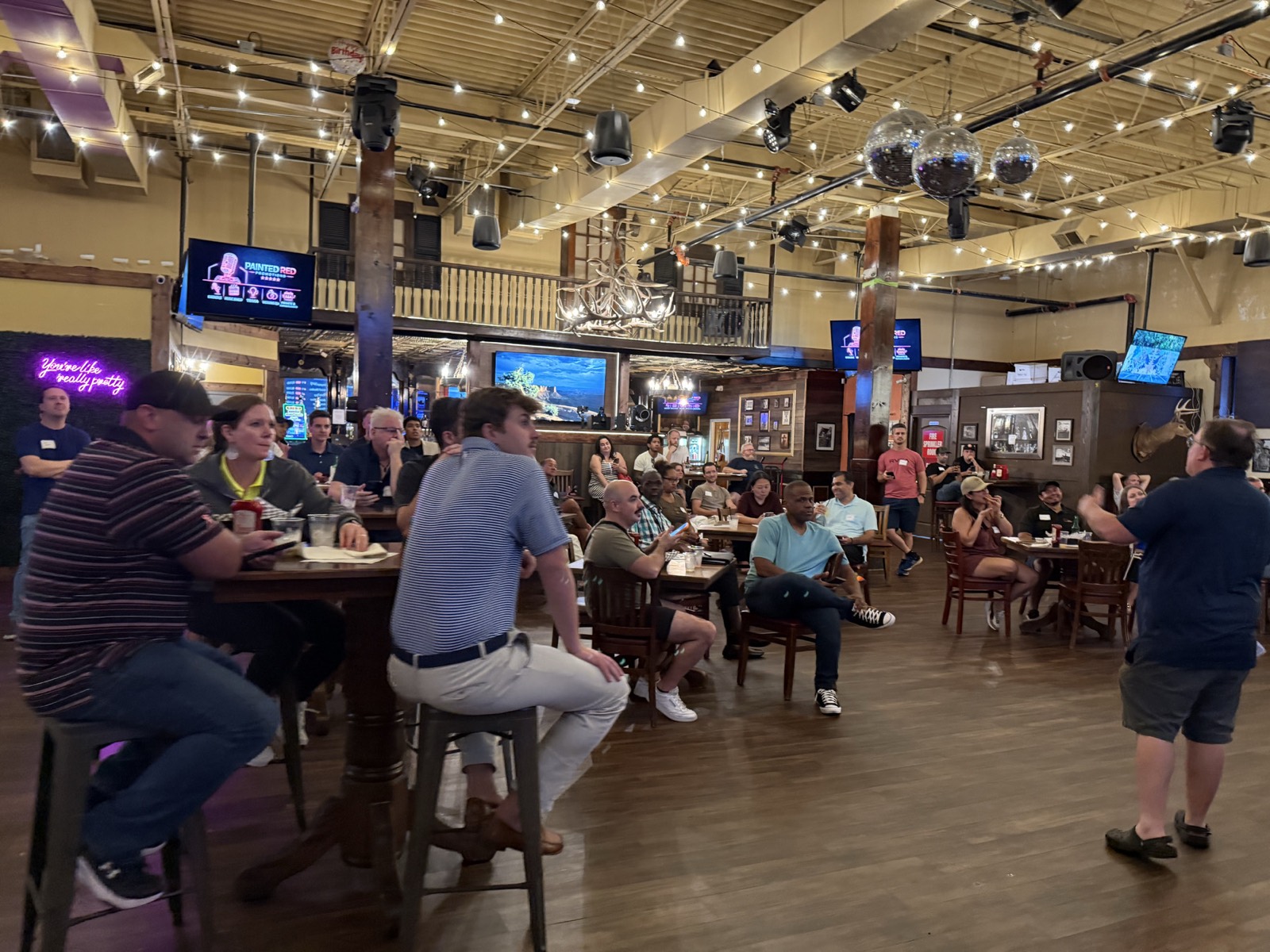 Investors networking on the floor at a Richmond RING meetup